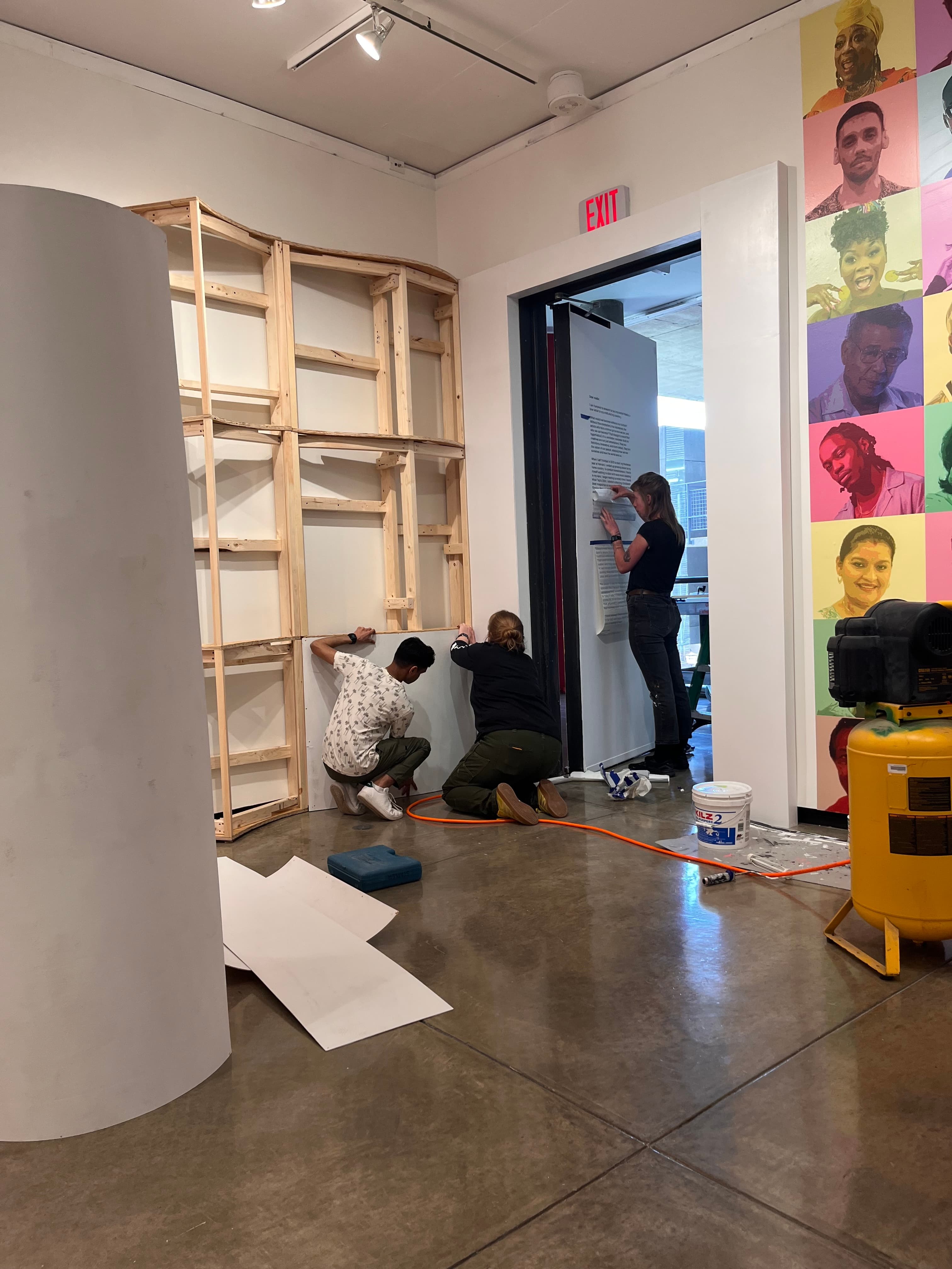 Assembling the wooden book sculpture framework in the gallery space