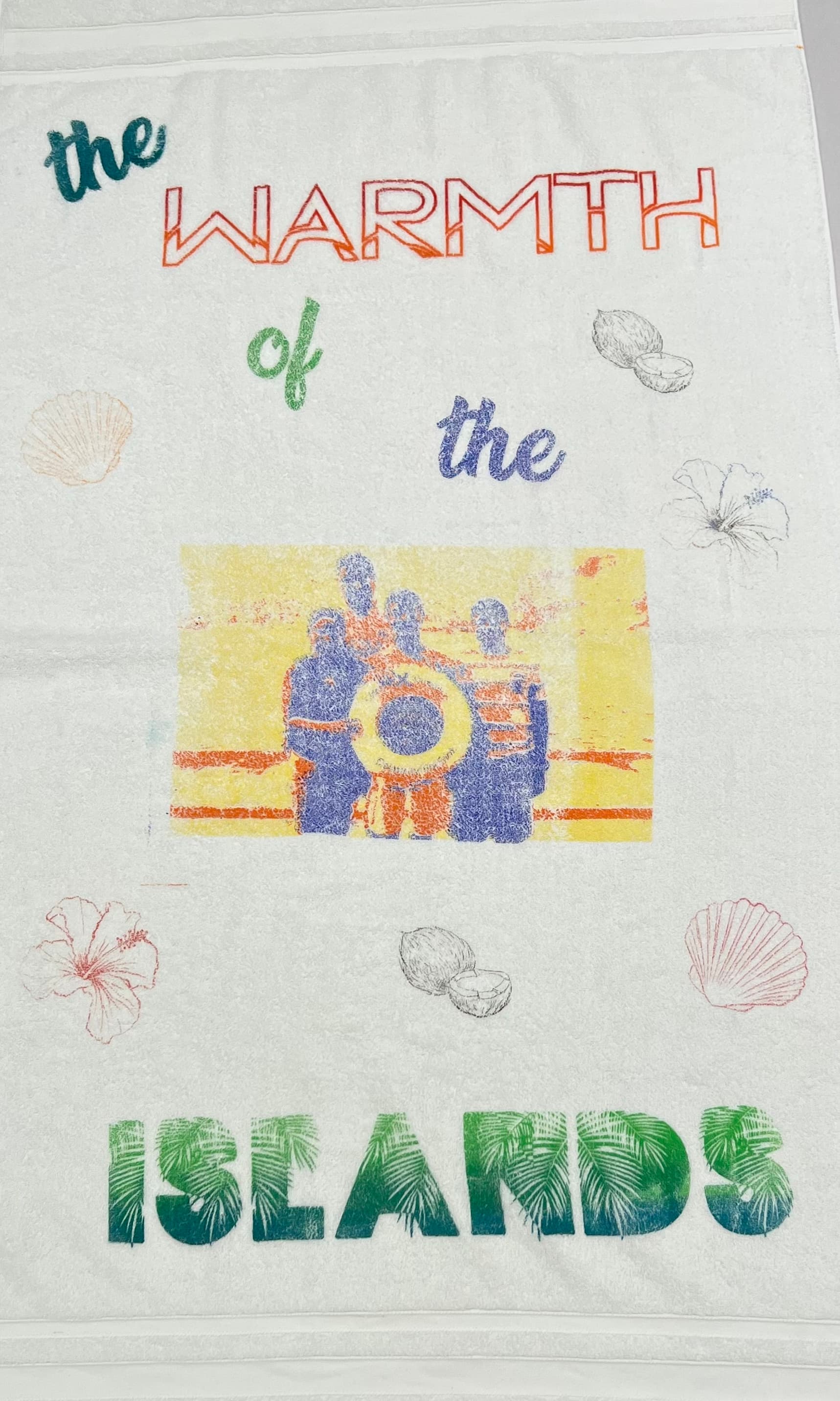 Silkscreened beach towel featuring 'The Warmth of the Islands' design with tropical elements